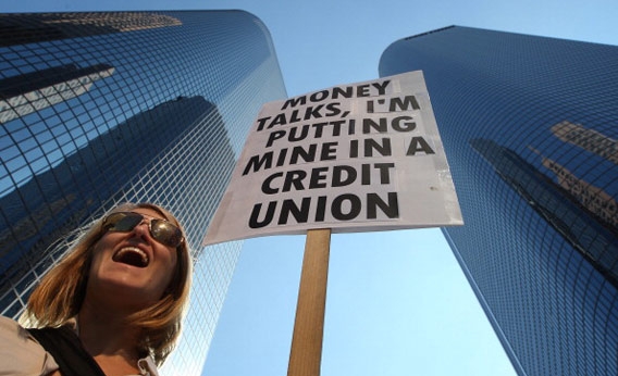 woman picketing downtown with sign