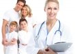 female doctor smiling with family of four in background